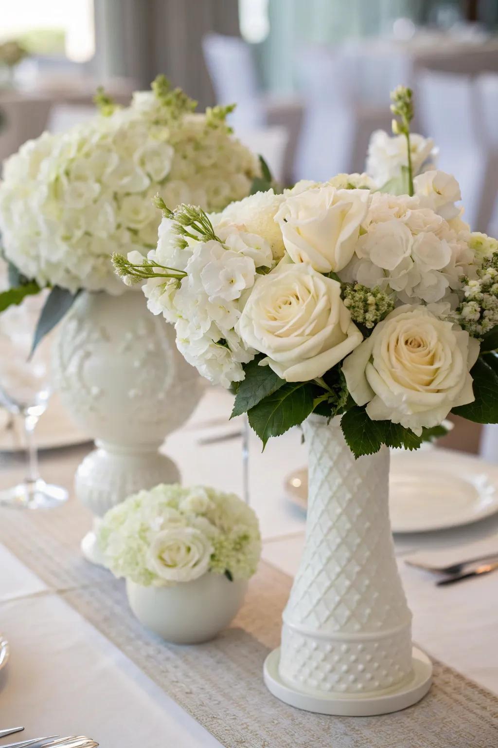 White flowers serve as a captivating centerpiece for an all-white dining affair.