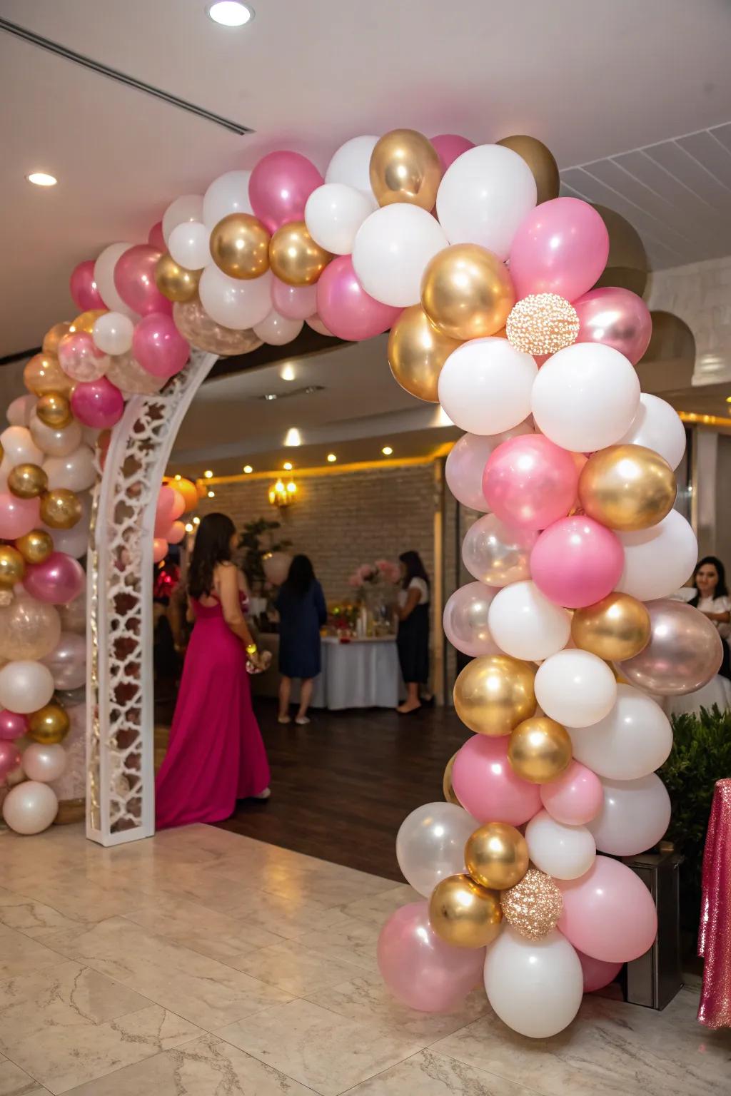 A breathtaking balloon arch shimmering in shades of pink, gold, and white.