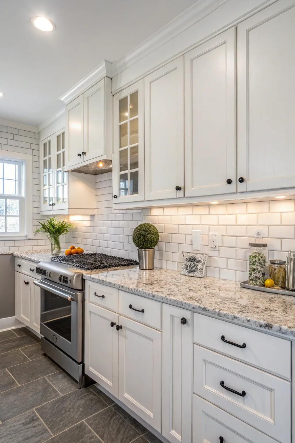 A timeless rectangular tile backsplash beautifully matches the white cabinets and granite surfaces.