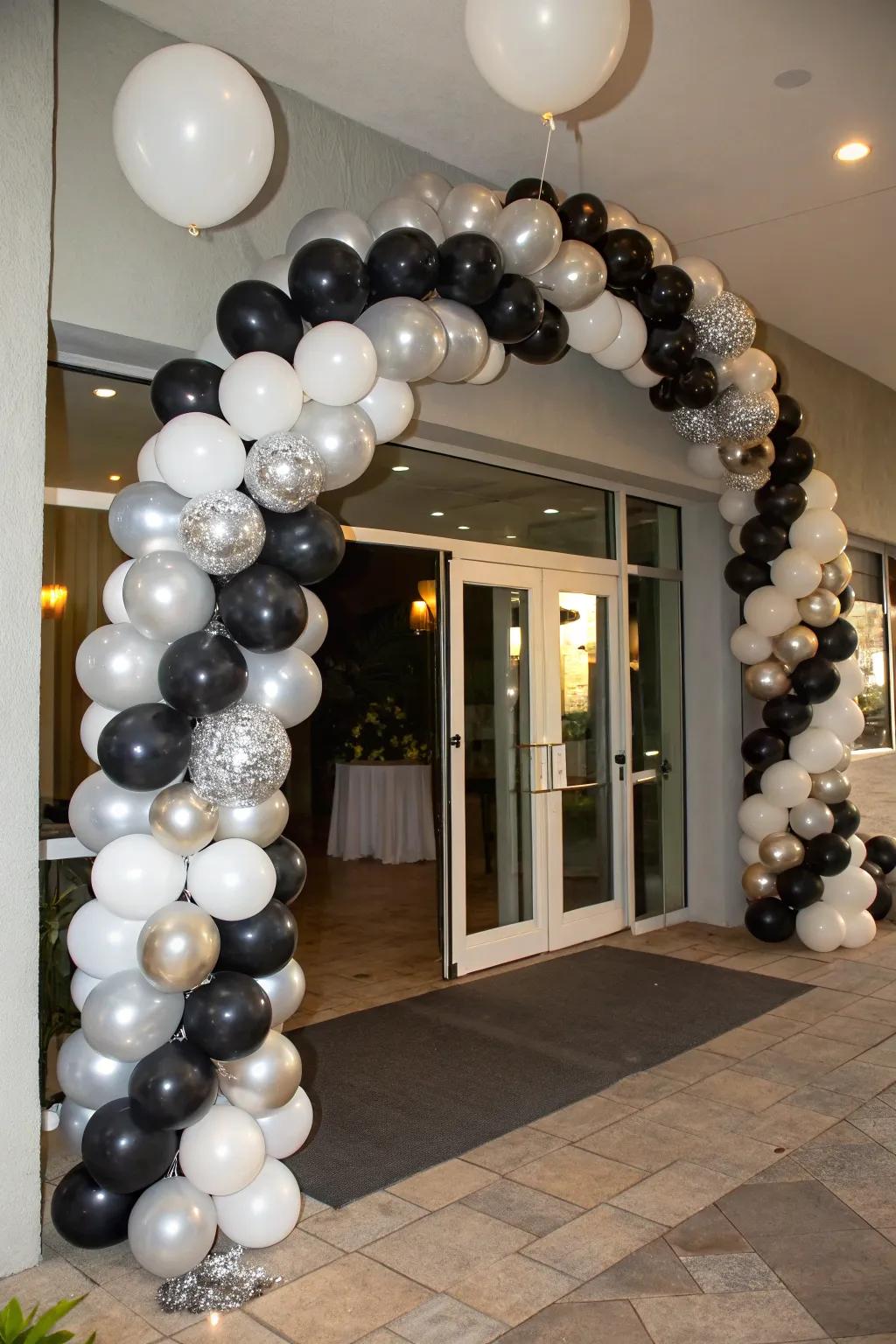 An elegant balloon garland in onyx, argent, and alabaster.