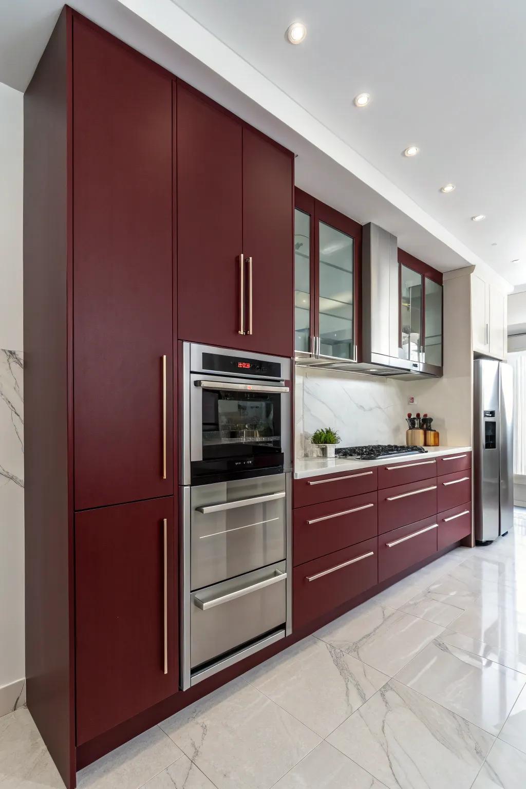 Understated kitchen design showcasing handle-free, crimson-toned cabinets.