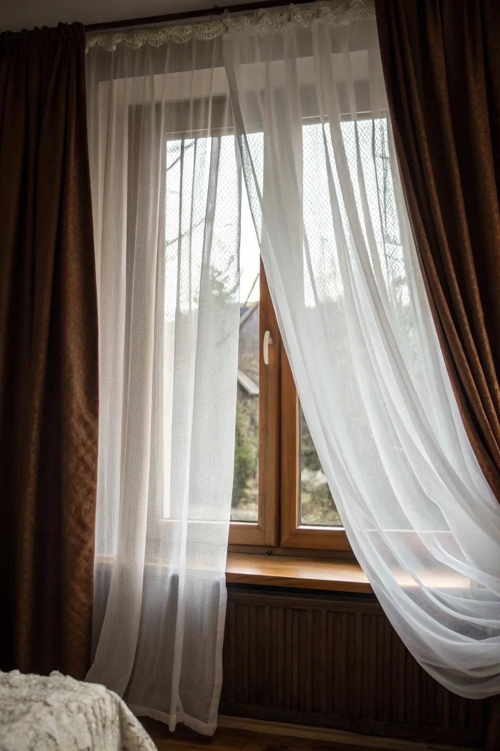 Layering sheer and opaque curtains creates a comfortable and private atmosphere in the bedroom.