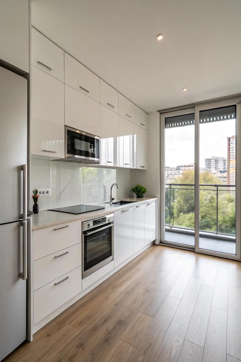 A minimalist one-wall kitchen featuring glossy cabinets and stainless steel appliances.