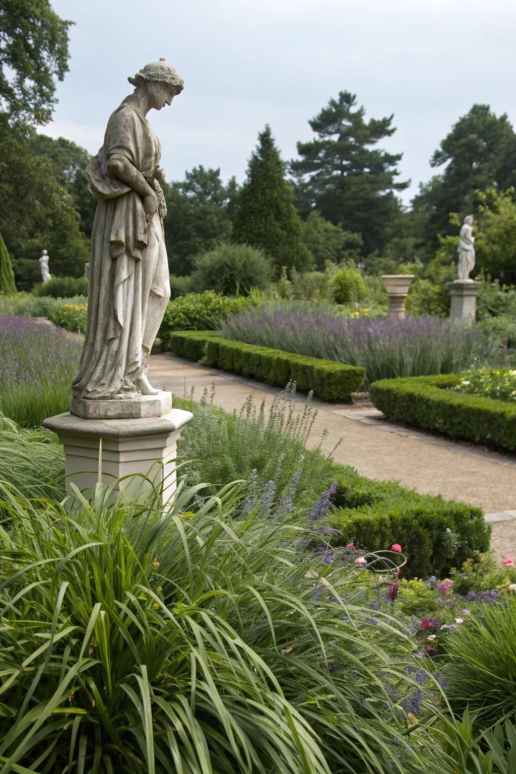 A garden statue elegantly accentuated by the lush liriope surrounding it.