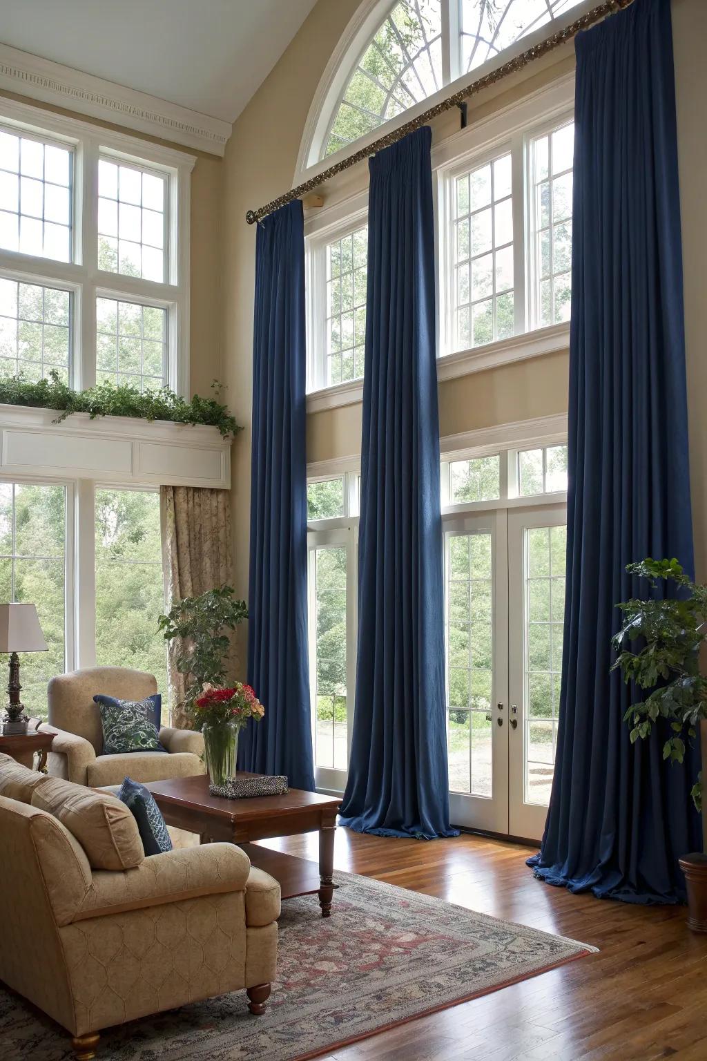 Elegant full-length window coverings add height and drama to this glam living room.