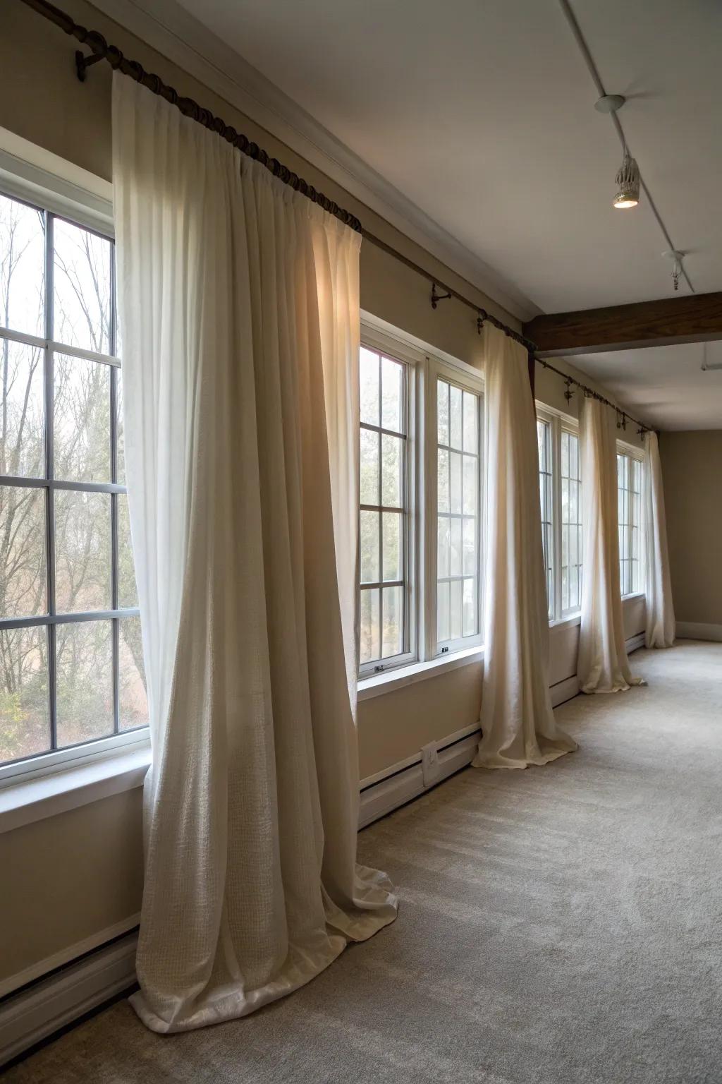 Hanging drapes strategically creates the illusion of larger windows.