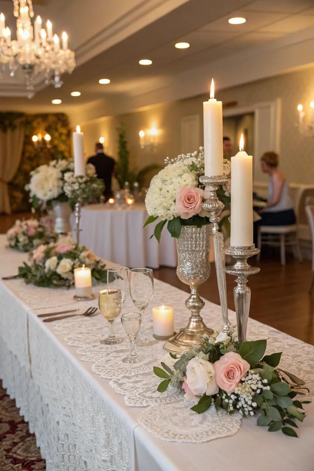 The bride and groom are seated at a table with vintage light stands and woven fabric squares.