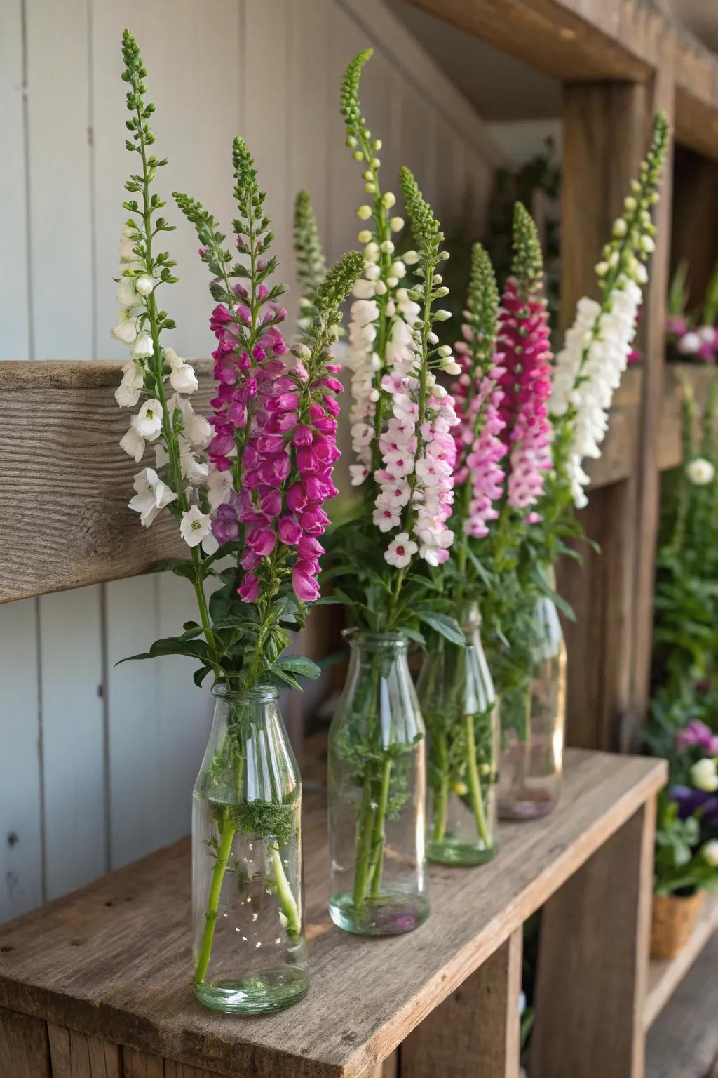 Glass bottles repurposed as vases generate a sustainable arrangement.
