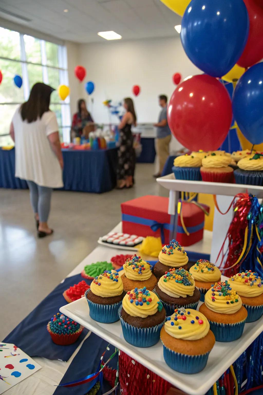 A themed sweet presentation featuring academic color cupcakes serves as a delightful treat and decorative centerpiece.