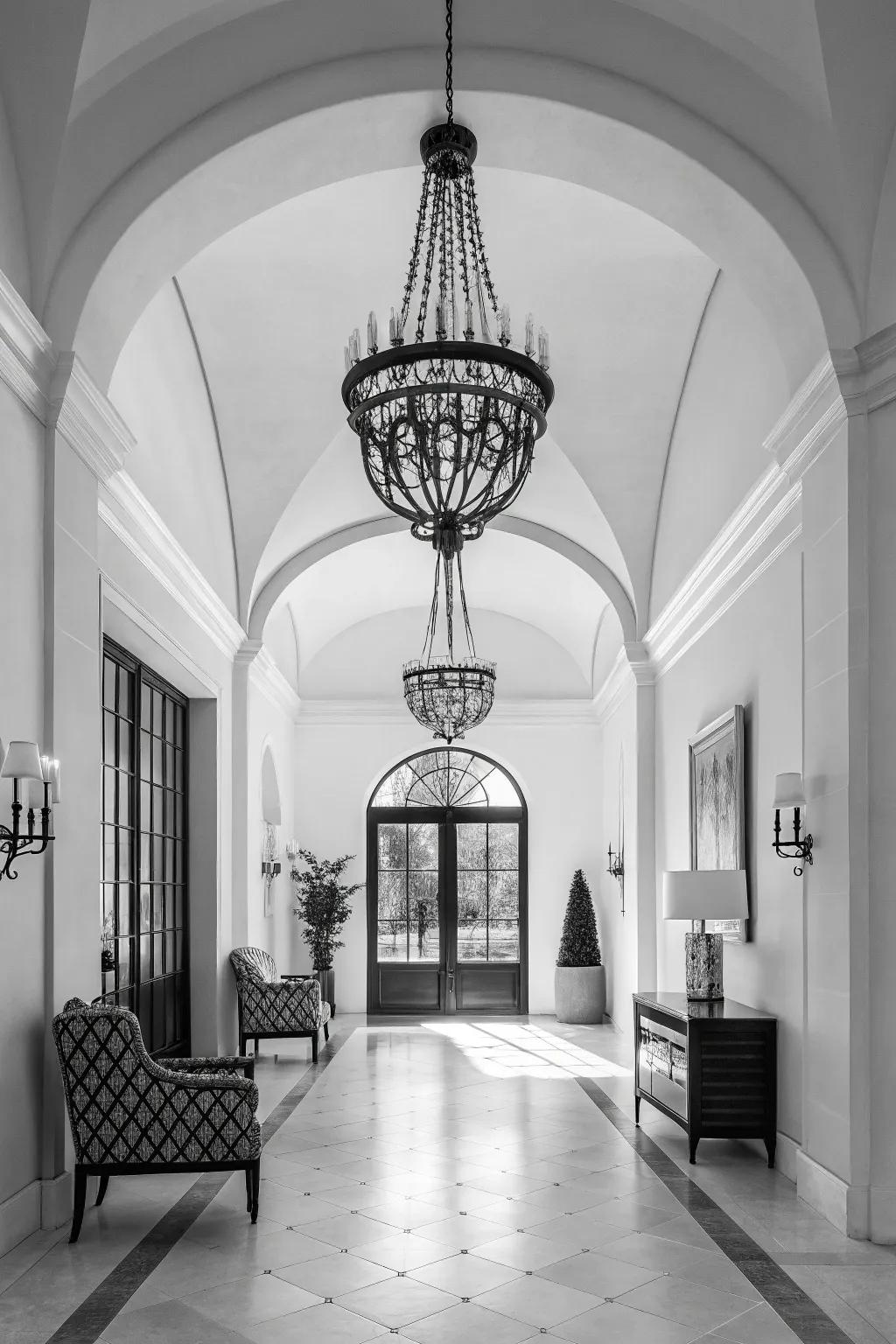 A monochrome chandelier adds sophistication to this modern entrance hall.