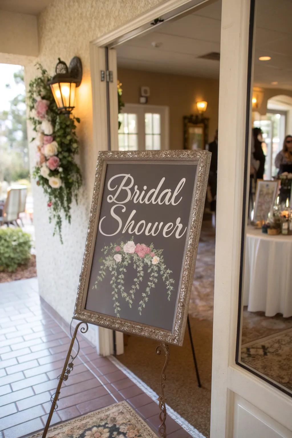 A glamorous reflective surface display featuring penmanship imparts sophistication to the bridal shower doorway.