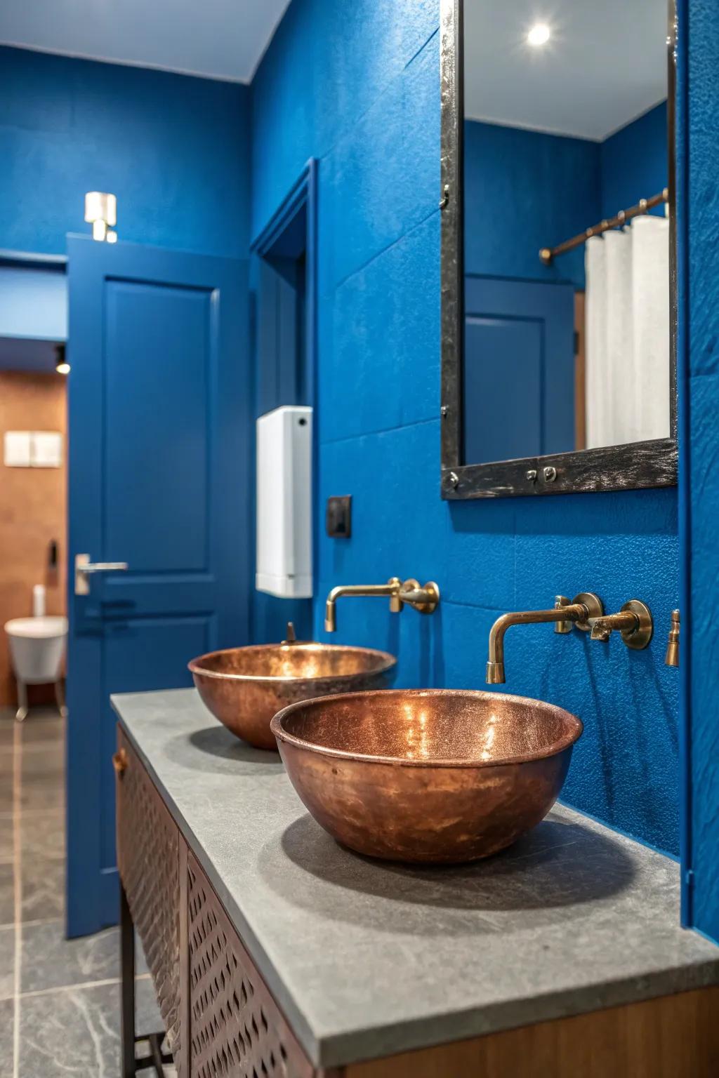 Bold blue walls make the warm tones of this copper sink pop.