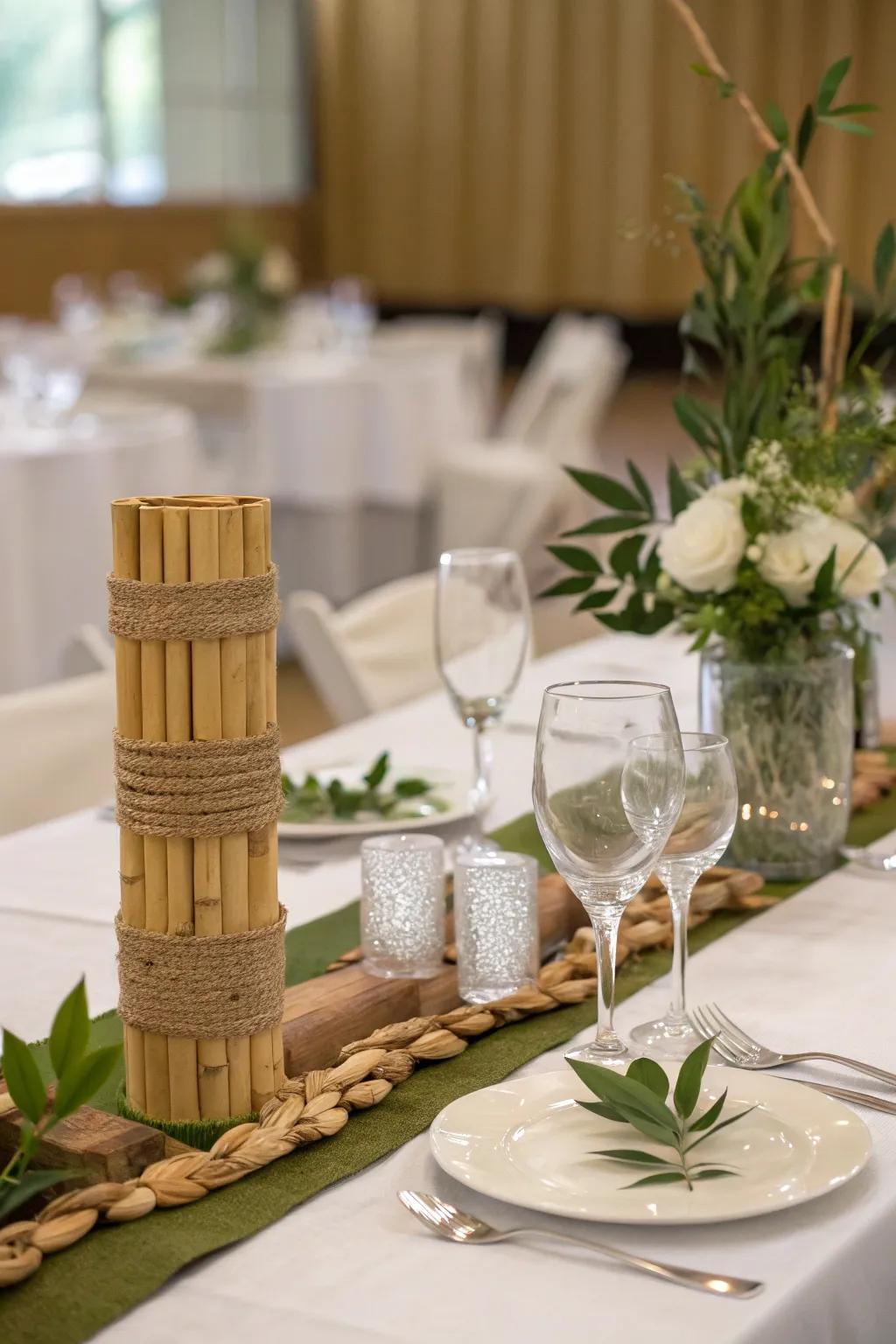The bride and groom are seated at a table with bamboo and upcycled glassware.