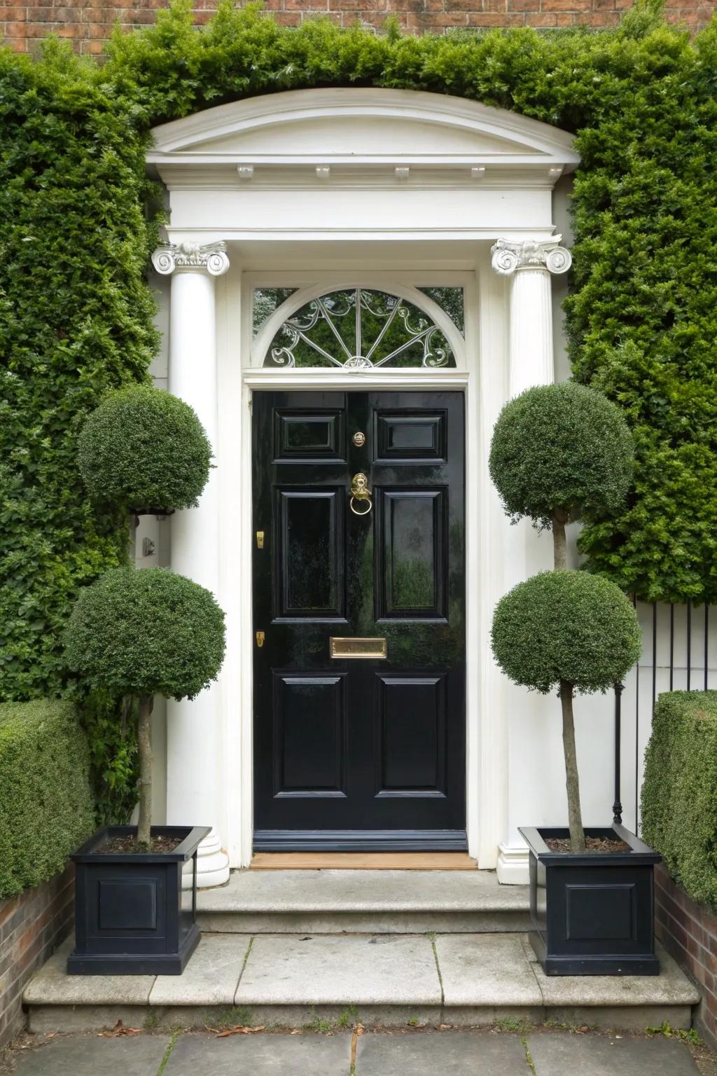 Sculpted foliage enhances sophistication and a touch of whimsy to a black door.