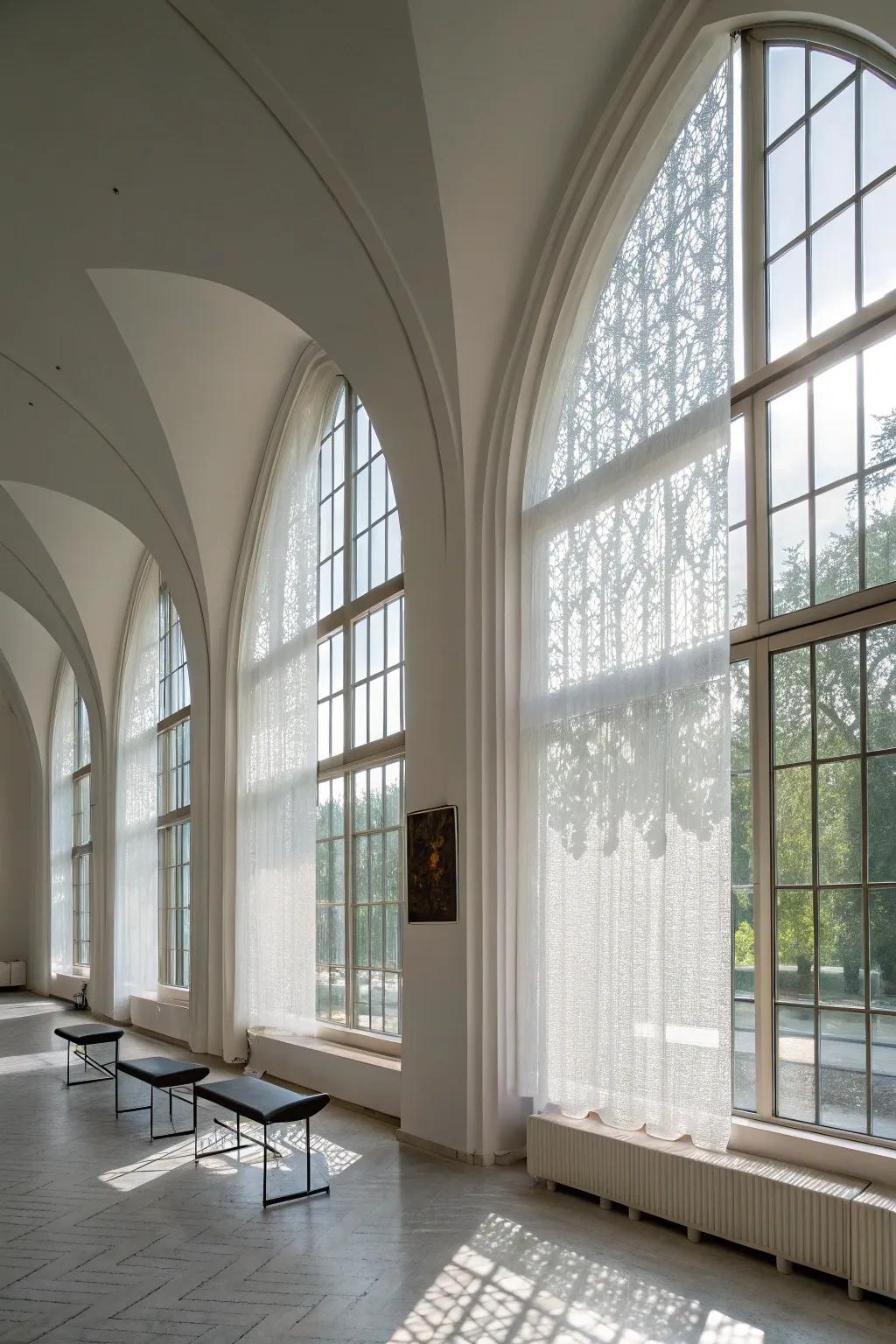 Modern minimalist space featuring semi-opaque screens on arched windows.