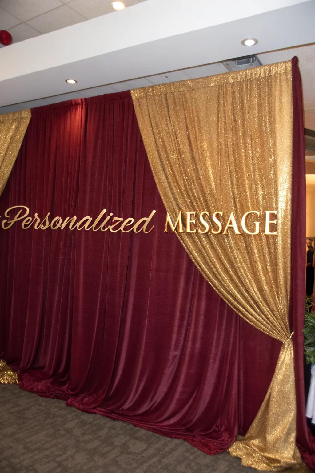 Craft a central point with opulent draped backdrops of claret and gilded fabrics.