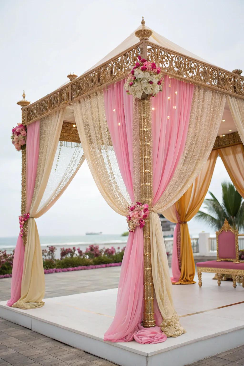 Sumptuous weaved textiles within rose and gold enveloping a mandap.