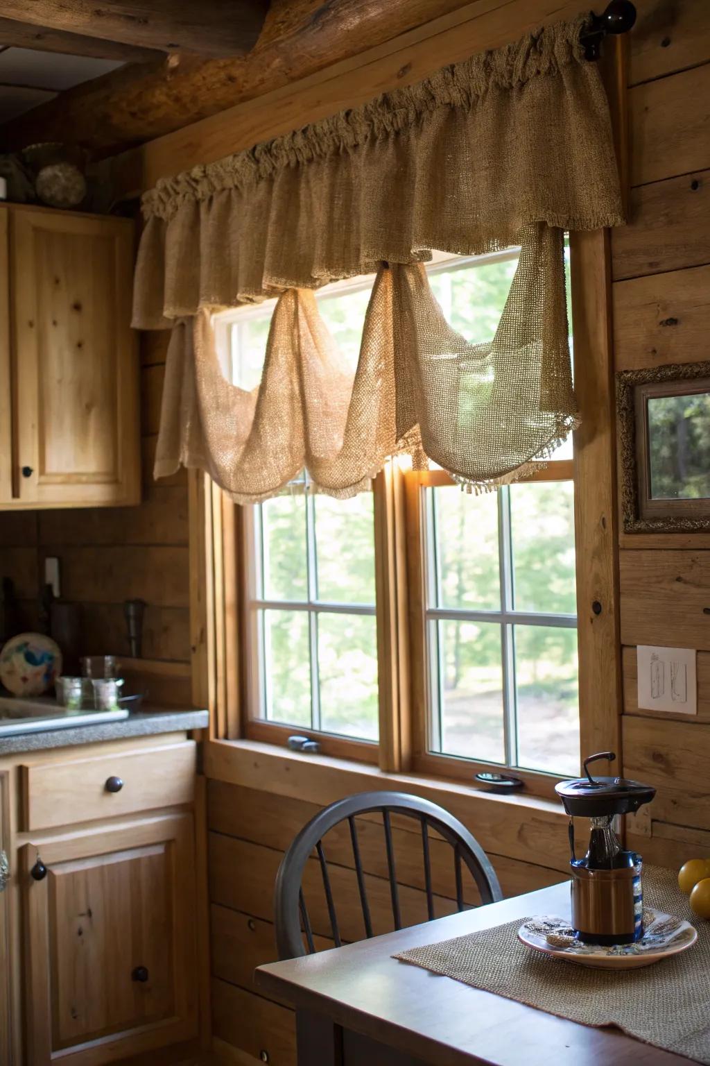 A welcoming kitchen featuring a hessian valance that complements the country wood aspects of the area.
