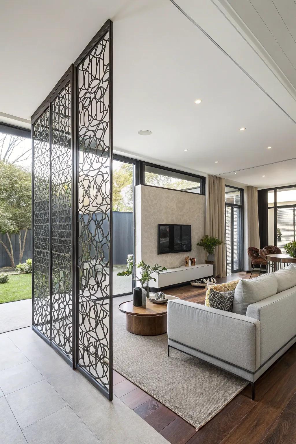 A polished metal screen partition creates well-defined zones within a spacious open-plan living area.