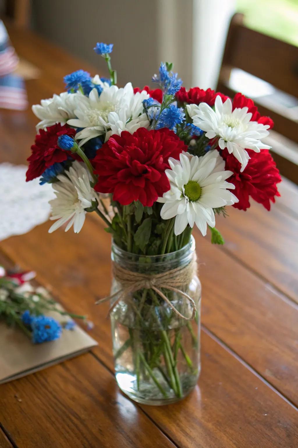 Patriotic flowers in a simple vintage glass jar arrangement.