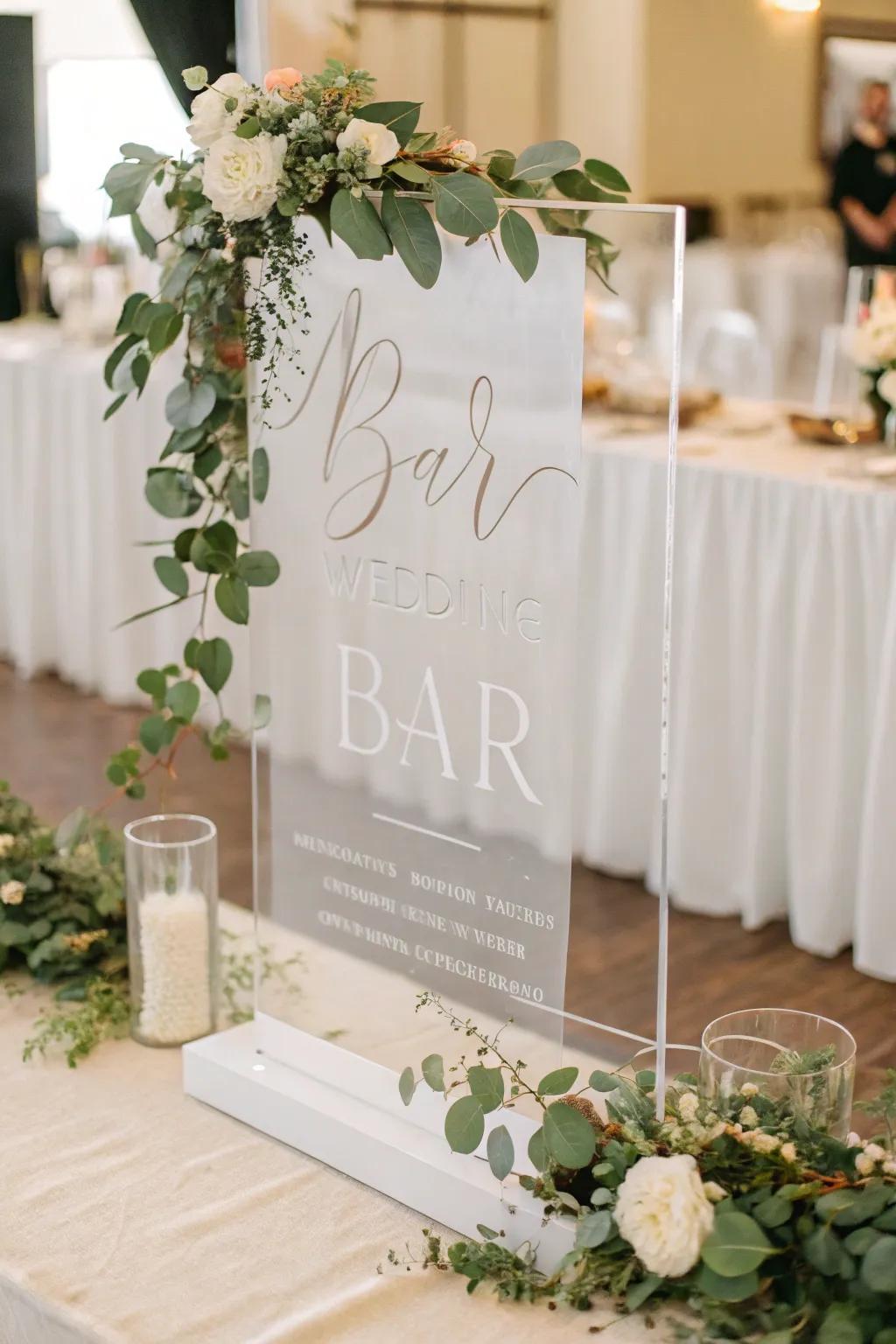 A refined clear bar sign featuring modern typography and foliage.