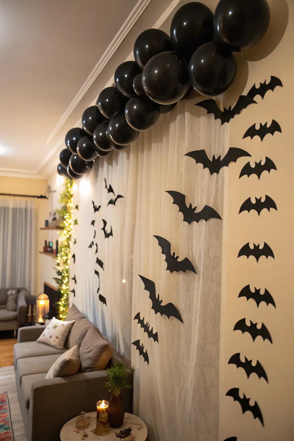 A garland of charcoal air spheres and paper chiroptera contributes playful drama