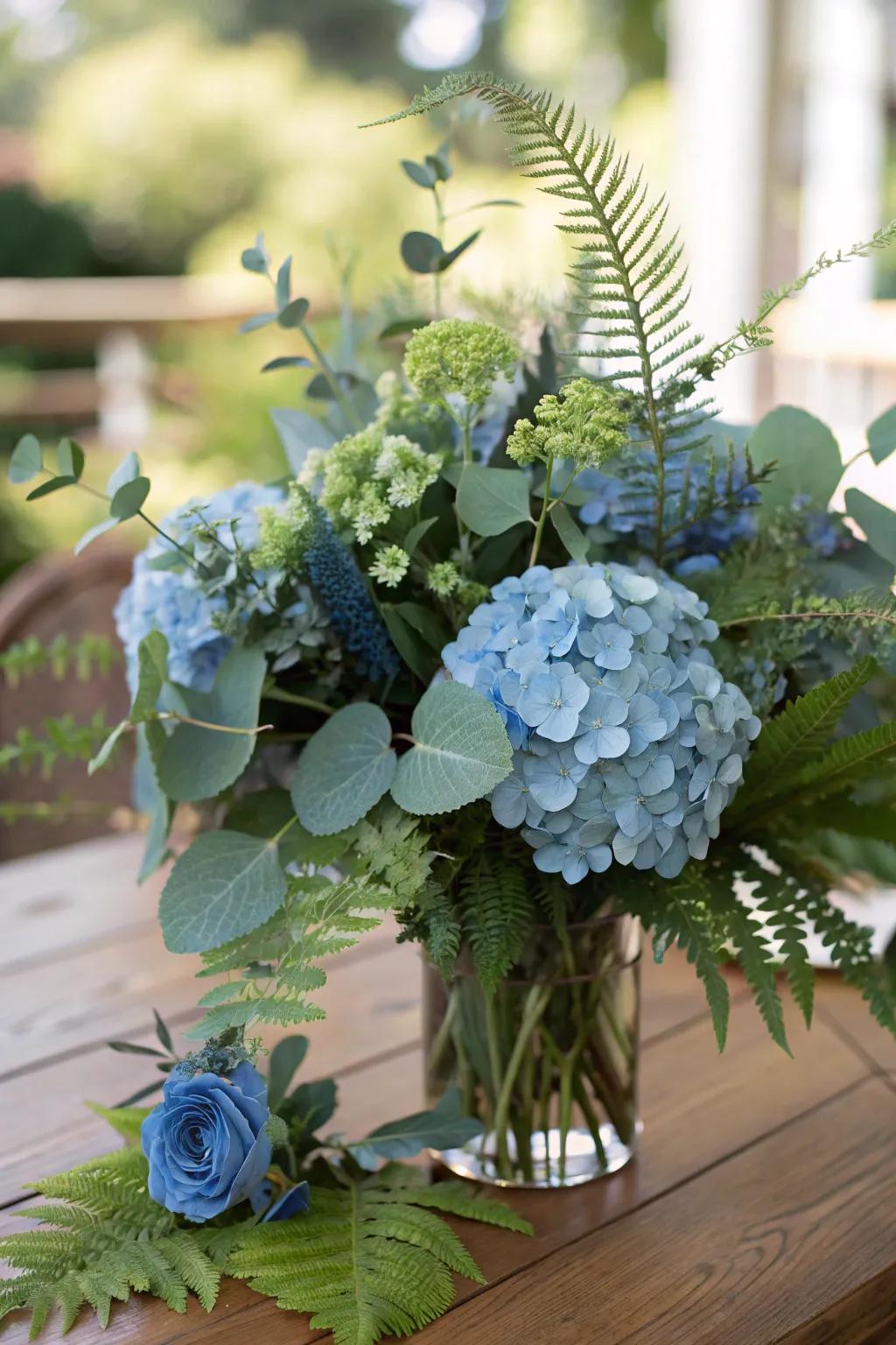 Verdant foliage intermingled with blue hydrangeas yields a full, textured result.