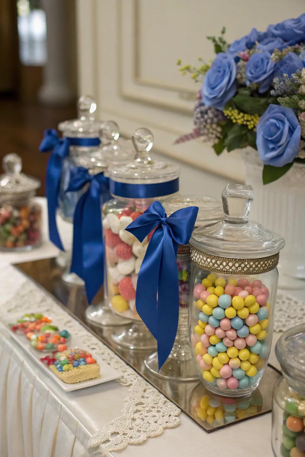 Candy containers ornamented with elegant royal blue ribbons.