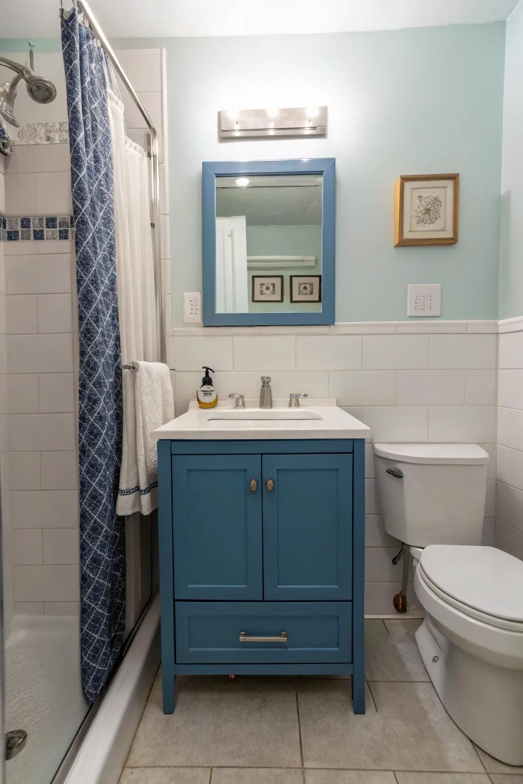 A modern blue vanity is a standout feature in this stylish bathroom.