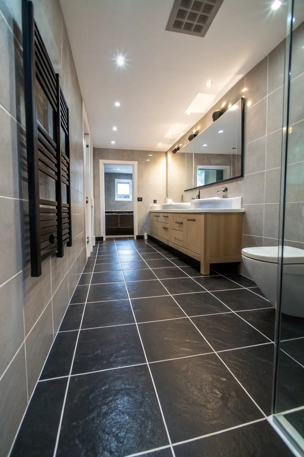 Expansive dark coverings generate a consistent and open feel within this bathroom.