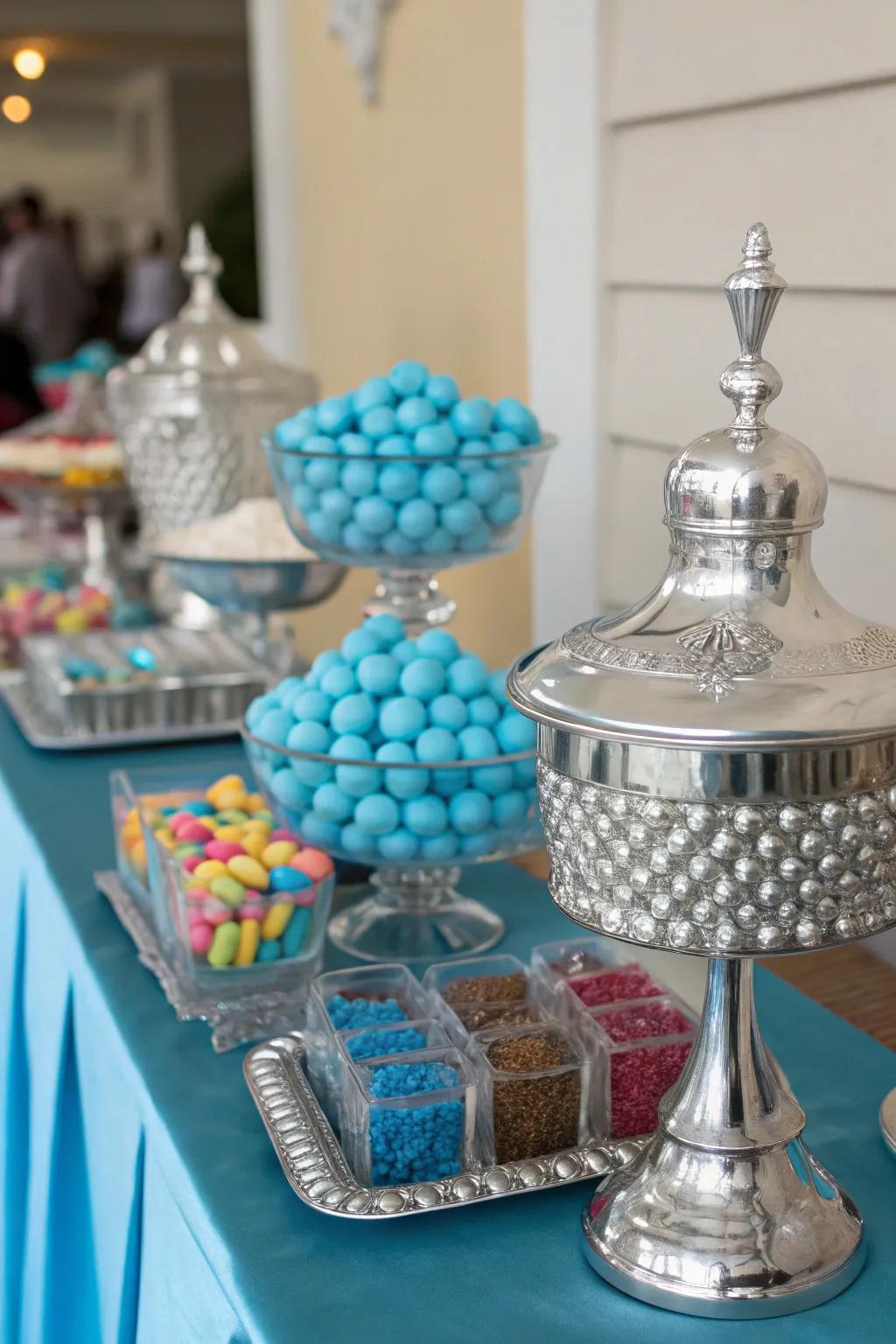 Elegant silver accents enhancing the royal blue candy table.