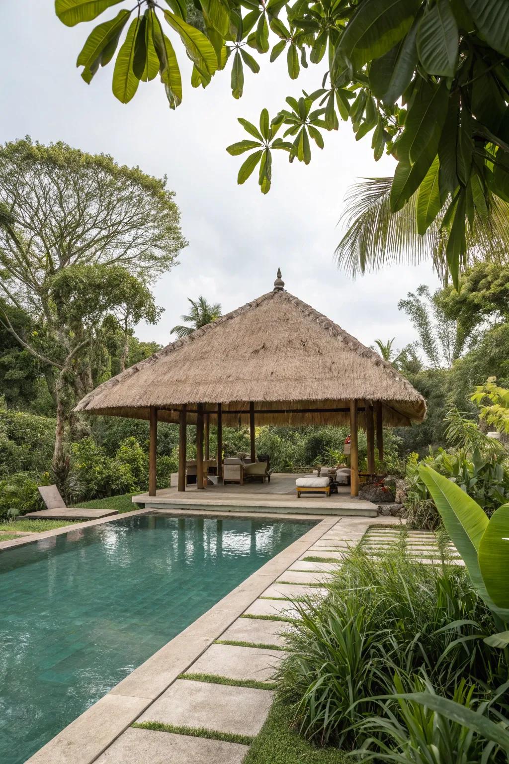 A thatched roof pavilion designs a tropical getaway right in your backyard.