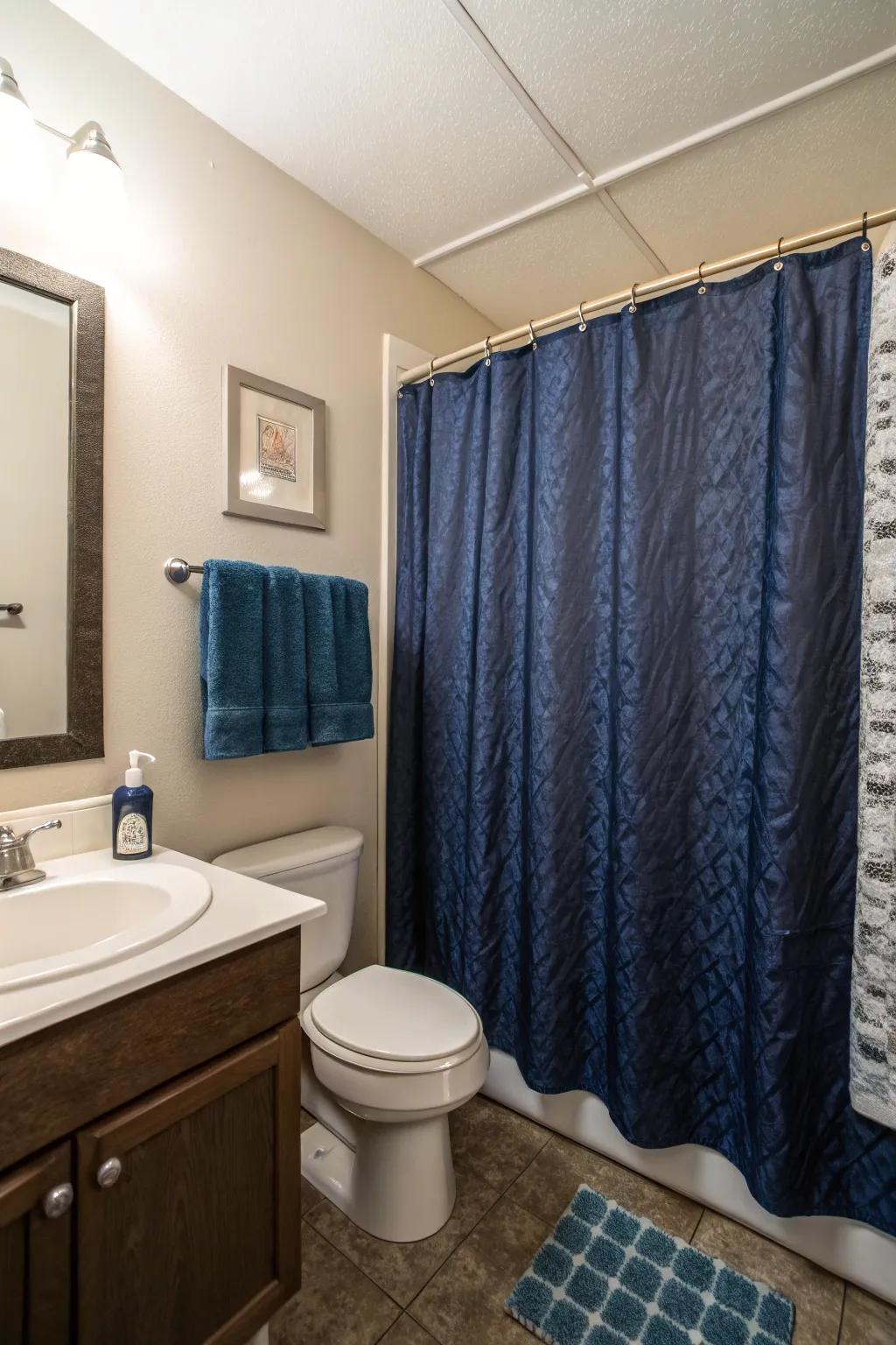 Deep blue shower curtains make a strong statement in this compact bathroom.