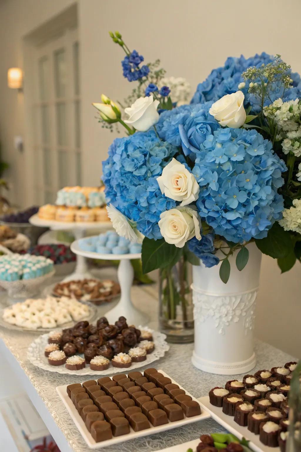 Blue floral arrangements bringing a fresh, natural element to the candy table.
