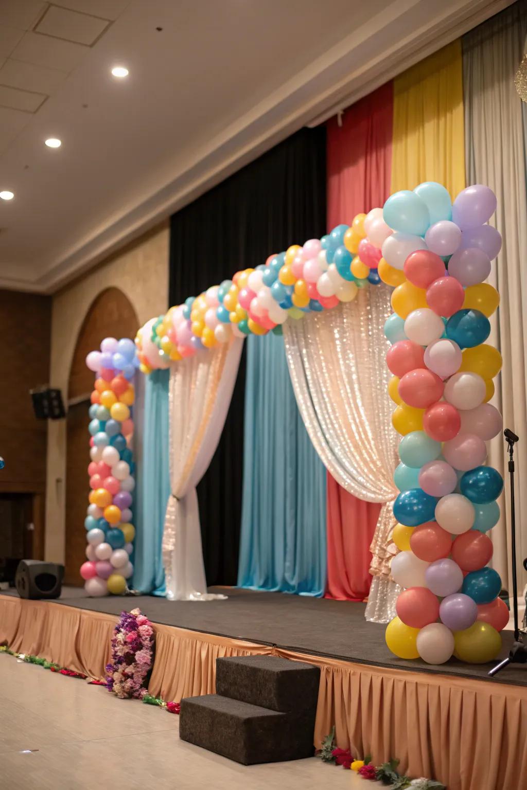 A harmonized stage layout incorporating balloons and graceful drapes.