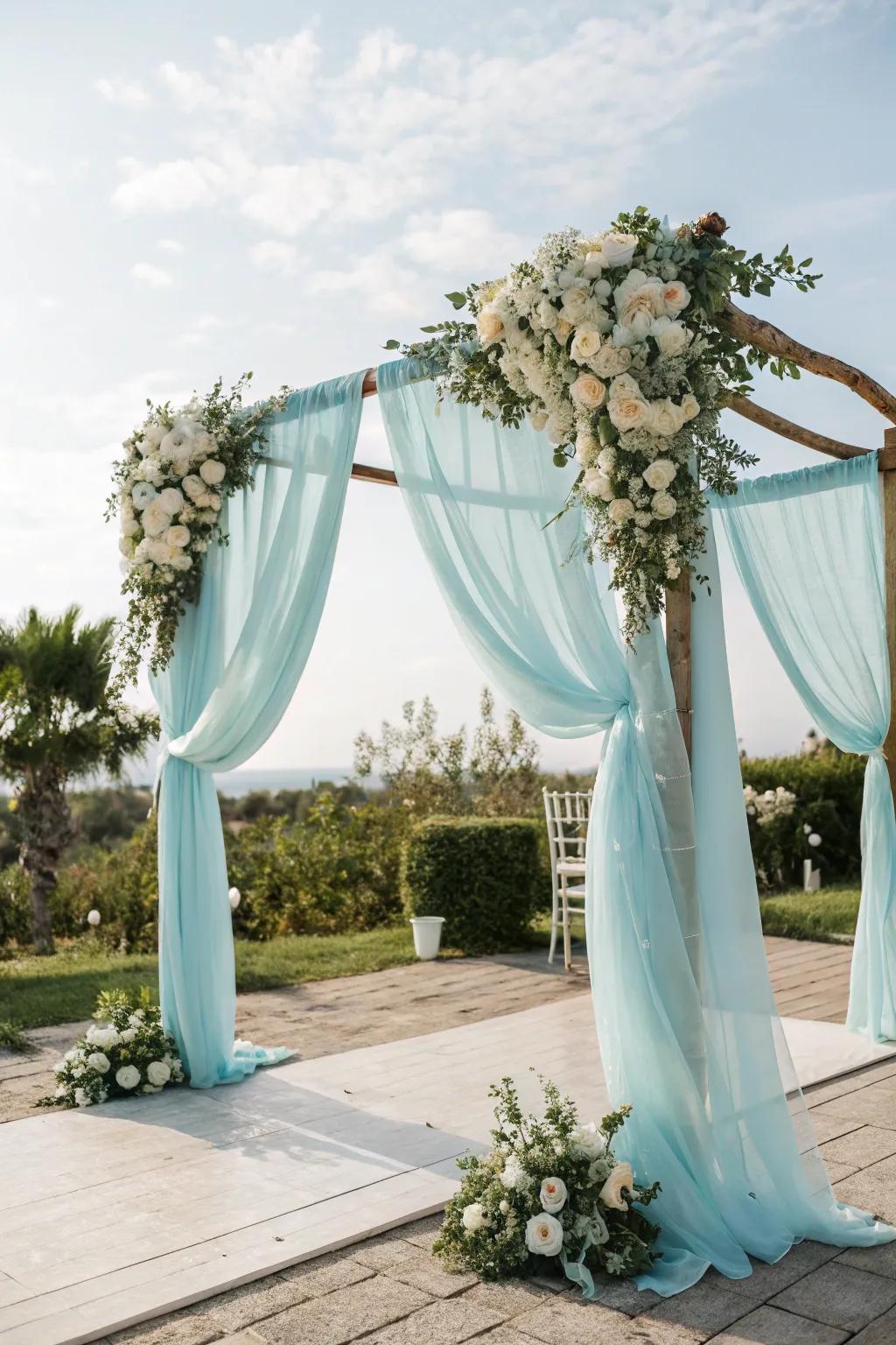 A soft blue wedding arch establishes a striking ceremonial centerpiece.