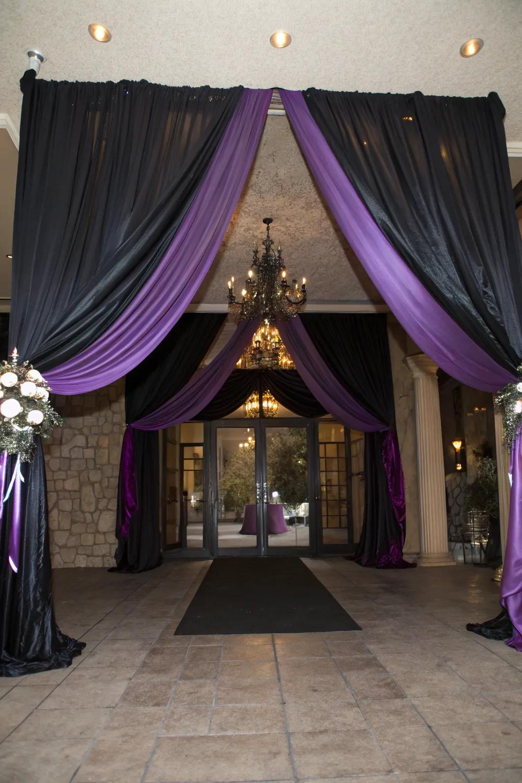Elegant venue entrance decor with onyx and violet fabric.