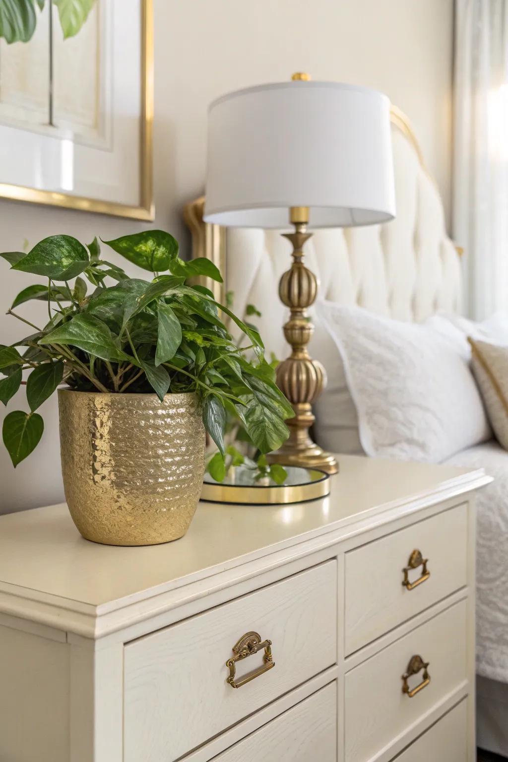 Greenery in a gold pot brings a refreshing touch to the bedroom.