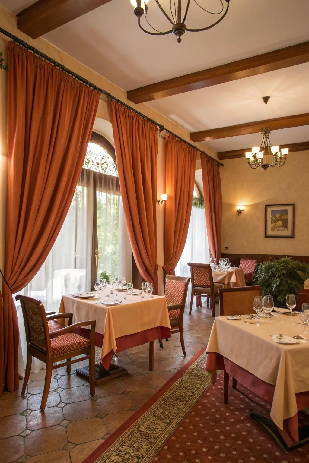 Terracotta drapes establishing a snug and warm ambiance in a dining room.