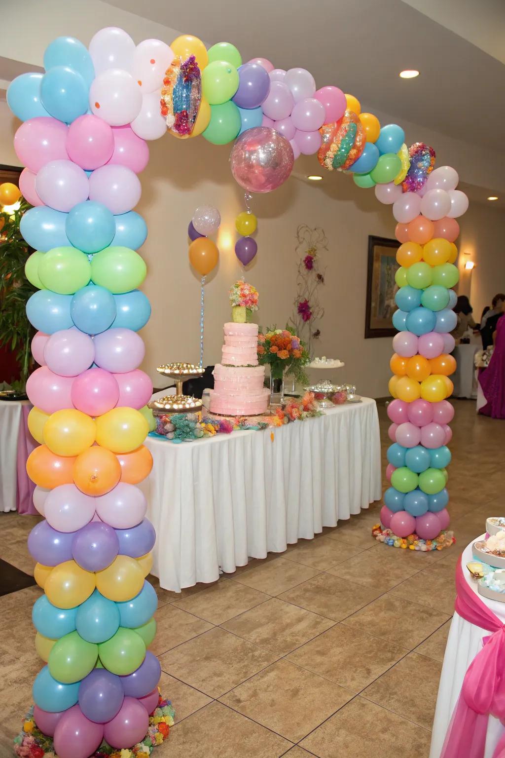 Balloon pillars elegantly frame the cake display.
