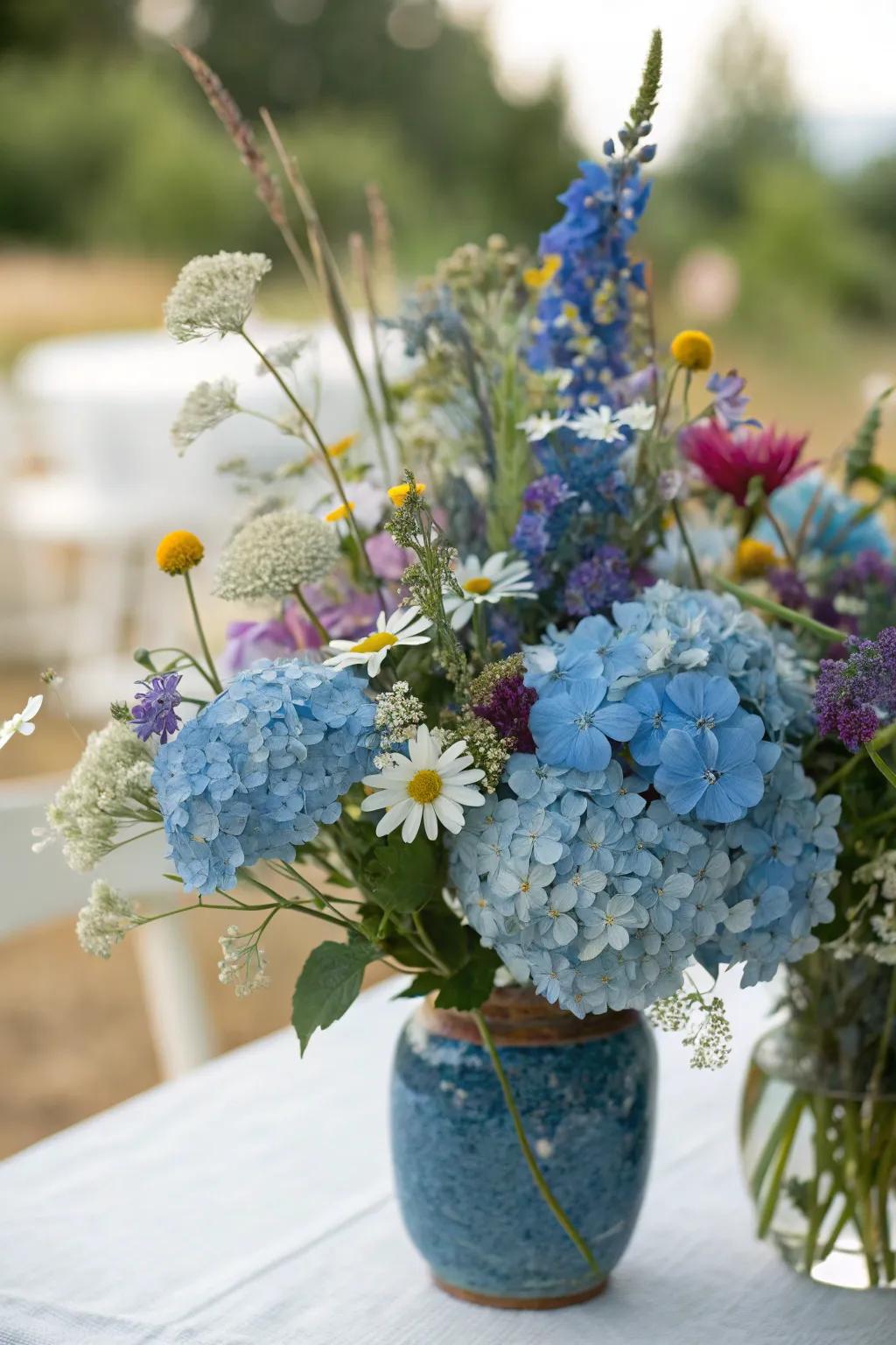 Blue hydrangeas and wildflowers equate to a bohemian-inspired centerpiece.
