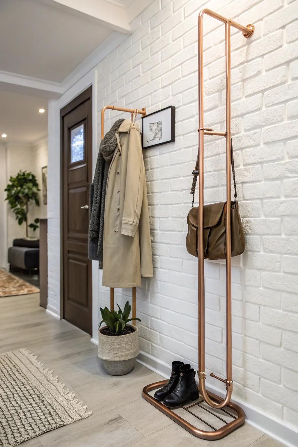 A bronze plumbing coat rack imparts sophistication and warmth to this chic entrance area.