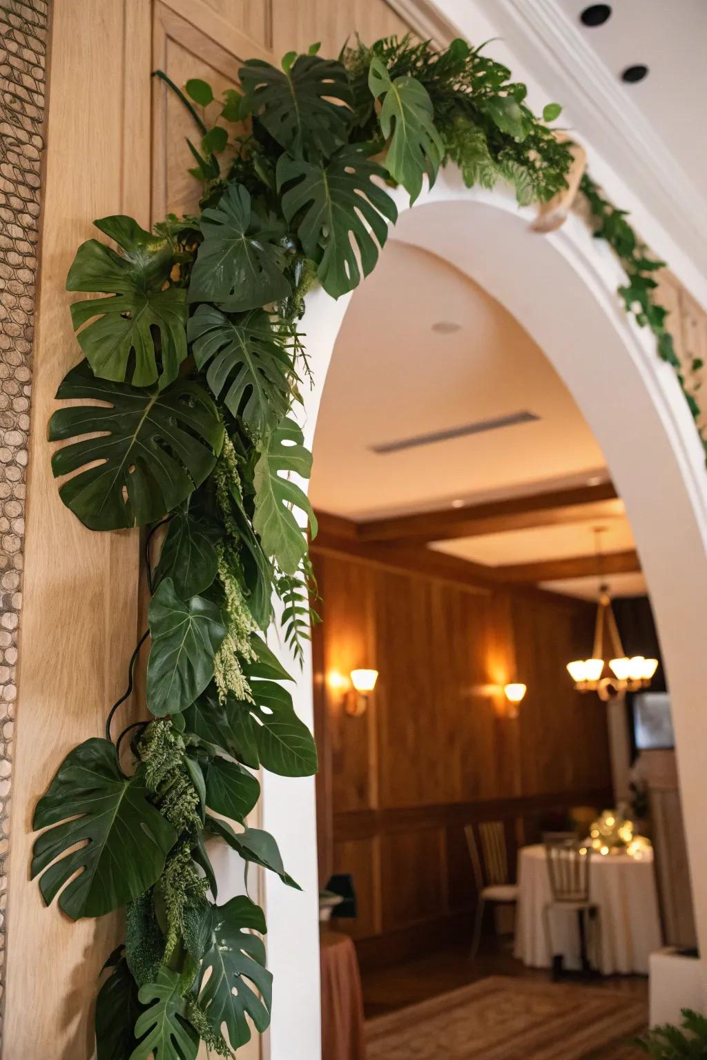 A gorgeous garland made of monstera leaves enhances an archway.