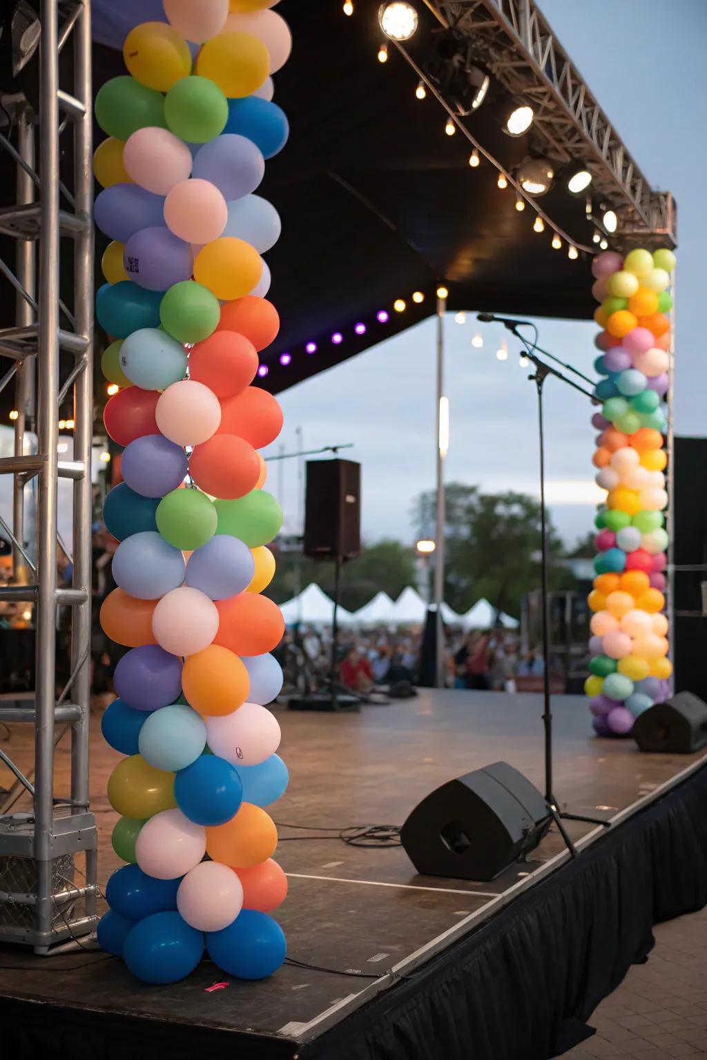 Balloon pillars delineating the performance zone on the stage.